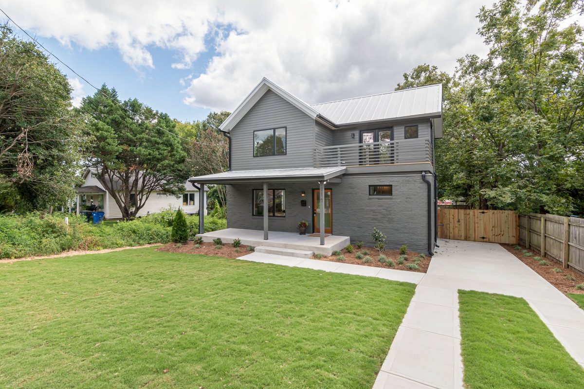 Gray two-story house with a front porch and a fresh lawn
